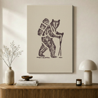 Gallery-wrapped canvas print of a rustic bear hiker illustration in brown on beige, styled above a wooden sideboard with neutral Scandinavian home decor