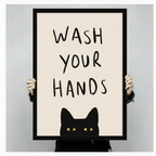 Hands holding large framed black cat wash your hands canvas print - full artwork view of peekaboo cat with yellow eyes and hand-lettered quote