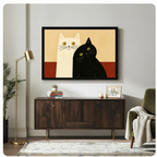 Person in white knit sweater holding up a large black framed minimalist black and white cat canvas art print against a neutral gray background, front-facing horizontal product display