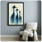 Blue heron trio watercolor framed wall art in black frame hung on light blue-grey wall beside white linen armchair with throw blanket