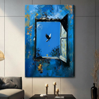 Canvas wrap wall art featuring a dramatic impasto oil painting of a crumbling blue wall with an open window, a soaring bird, golden moon, yellow butterflies, and a small figure playing guitar, hung on a gray wall in a contemporary living room