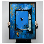 Person holding a large black framed surreal oil painting print of a weathered blue wall with an open window, flying bird, crescent moon, and a tiny musician figure, shown against a neutral gray background