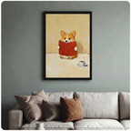 Black-framed corgi reading art print above a beige sofa on a sage green wall, whimsical dog wall decor for living room