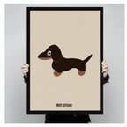 Hands holding a large black framed cute dachshund canvas art print against a neutral light gray background, front-facing product display