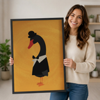 Smiling woman holding large framed canvas art print of a dapper black swan in bowler hat and bow tie on warm golden background