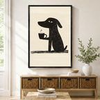 Funny dog holding steaming coffee cup minimalist linocut style framed wall art in black frame displayed above a wooden sideboard with wicker baskets in a bright Scandinavian entryway