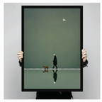 Hands holding framed elderly person in black coat and brown dog walking on still water with mirrored reflection minimalist illustration canvas – olive green tonal background white bird canvas wall art size reference display