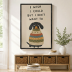 Black framed funny dachshund I Wish I Could But I Don't Want To quote canvas art with a grumpy black dachshund in a colorful striped sweater, displayed above a rattan storage console in a bright entryway