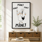Black framed funny seagull Mine canvas art with a cartoon white seagull raising five finger-shaped baby seagulls and shouting Mine Mine Mine in bold black lettering on a clean white background, displayed above a rattan storage console in a bright entryway