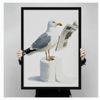 Person holding a large framed funny seagull reading a newspaper print standing on toilet paper rolls humorous coastal bird bathroom wall art on a light gray background