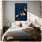 Framed luxury gold foil four cranes canvas wall art with elegant golden crane silhouettes on a deep navy blue textured background hung above a wooden bed with white bedding in a sunlit minimalist bedroom