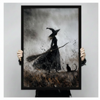 Hands holding gothic witch and black cat canvas print against light gray background — dark moody wall art product display shot