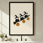 Black framed Halloween witch birds perched on broomstick with glowing jack-o-lantern pumpkins wall art print above bathroom sink