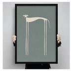 Person holding a large black-framed minimalist greyhound art print featuring a cream abstract dog with impossibly long legs on a muted teal-grey background, showcasing print size and quality