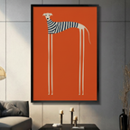 Framed canvas wall art of a minimalist white greyhound wearing a navy striped sweater on a bold orange background, displayed above a console table in a modern living room