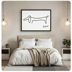 Black framed Picasso minimalist one-line dachshund horizontal canvas art on white background above a bed with white linen bedding, a taupe throw blanket, white open nightstands, potted plants, and globe pendant lights in a modern bedroom
