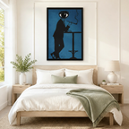 Black framed surrealist eye-head man smoking pipe canvas art in deep blue above a bed with white linen bedding, a sage throw blanket, white nightstands, potted plants, and a ceramic table lamp
