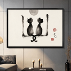 Two black cats ink wash painting in black frame displayed on dark gray living room wall above candles — Chinese brush art wall decor