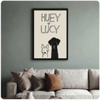 Black framed Huey and Lucy dog sketch wall art print on blue-grey wall above linen sofa