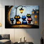 Frameless canvas print of quirky black cats with vivid blue, orange, green and red eyes under a glowing lantern, hung on a living room wall