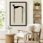 Bold framed wall art print of a minimalist black greyhound with a sleek arched back and ultra-long legs on a neutral linen-toned background, styled beside a linen armchair in a cozy Scandinavian reading corner