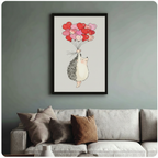 Whimsical black-framed poster of a rosy-cheeked hedgehog holding heart balloons, displayed above a neutral linen sofa on a sage green wall