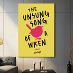 Gallery wrap stretched canvas of The Unsung Song of a Wren book cover art with yellow background and pink wren silhouette hung frameless on a dark gray wall above candlestick holders